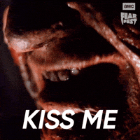 Sponsored gif. Close up of Freddy Krueger’s scarred mouth as he says, “Kiss me.” In the upper right corner is the AMC Fear Fest logo. Text also reads, “Kiss me.”