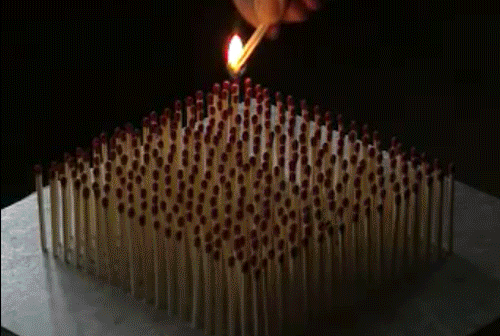 Video gif. Someone lights a bunch of matches that are arranged in a square. All the matches light at once and burn out at the same time, leaving behind charred bits.