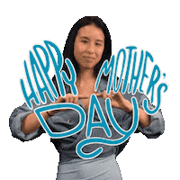 Digital art gif. Smiling woman draws the outline of a large cartoon purple heart with her hands in the air. In front of her, blue text reads, "Happy Mother's Day."