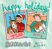 Illustrated gif. Characters from Alice Oseman's graphic novel Heartstopper are captured in polaroids. A bubblegum pink polaroid captioned "Charlie and a reindeer" depicts Charlie Spring in a Christmas sweater smiling with his puppy dressed in reindeer ears. A sea green polaroid captioned "Sleepy" shows Nick Nelson falling asleep underneath Christmas lights with the same puppy in his arms. Scrawled above the photos, cursive writing reads, "happy holidays!"