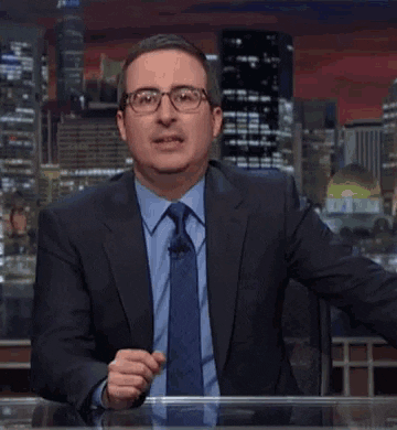 TV gif. John Oliver on Last Week Tonight sits at his desk and stares straight at the camera with a bored expression. He says, “cool” in a sarcastic, mocking manner.