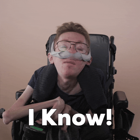 Reaction gif. A mobility-impaired white man using a power chair, a ventilator, and wearing retro-crossbar glasses says sassily, "I know!"
