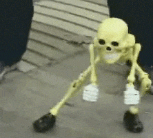 Video gif. Tiny skeleton puppet wearing black shoes leans over and shakes his hips from side to side, looking loose and vibing to the music. The puppeteer's legs are visible right behind the dancing skeleton. 