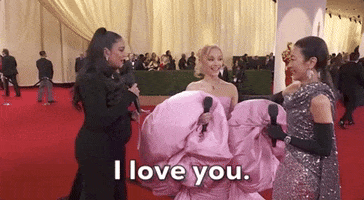 Oscars 2024 GIF. Michelle Yeoh blows emphatic kisses at Ariana Grande, who yelps “I love you” leaning in for a cheek-to-cheek hug.