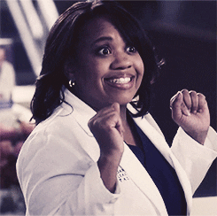 TV gif. Chandra Wilson as Miranda Bailey on Grey's Anatomy, smiles big and raises her hands up in celebration.