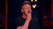 Reality TV gif. Gordon Ramsay on Next Level Chef opens his mouth to say something, but stops and places a finger on his mouth. He then turns to look at someone as if they have an answer.