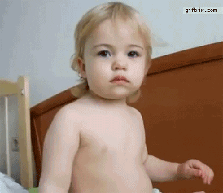 Video gif. Blonde baby looks at us, blank-faced, flashes the devil horns, and then goes back to whatever he was doing.