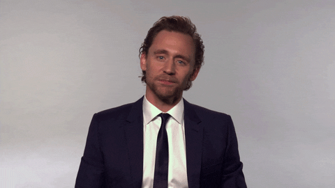 Tonight Show gif. Tom Hiddleston shrugs at us, raising his hands, tilting his head, and raising his eyebrows, his mouth in a straight line like, "What can you do?"