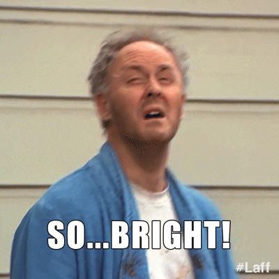 Video gif. A man comes out in a robe and stares disgustedly at the sky, exclaiming, "So... bright!"