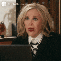 Schitt's Creek gif. Catherine O'Hara as Moira leans over a laptop and looks at someone across from her. She gasps and is genuinely shocked at what she has heard. She says, “Oh! Wow!” 