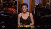 SNL gif. In monologue, Kristen Stewart fiddles with her hands and gestures "stop" while saying, "I'm like, so gay, dude," which appears as text.