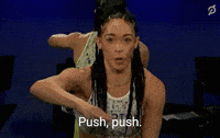 Video gif. Peloton instructor Hannah Frankson directing with her arm and saying &quot;push, push.&quot;