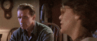 Movie gif. Arnold Schwarzenegger as Harry in True Lies. He sits in a chair listening to someone but is extremely skeptical, narrowing his eyes and staring at them intensely. The camera pans in on his face and zooms deeply, until his skeptical face fills the whole screen.