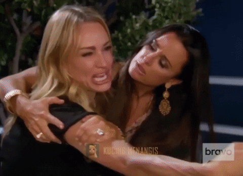 Reality TV gif. Taylor Armstrong from The Real Housewives of Beverly Hills is screaming, crying, yelling and pointing. The camera pans to who she's pointing at and it's a white cat who meows.
