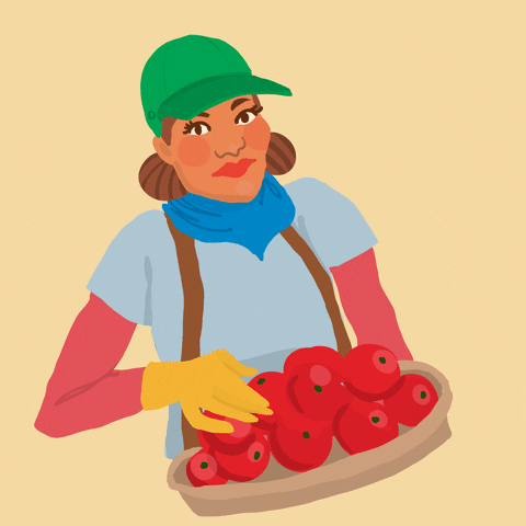 Digital art gif. Woman with a green cap, blue bandana scarf, and a light blue shirt on top of a red long sleeve undershirt smiles and closes her eyes happily as she holds a basket of ripe red apples.