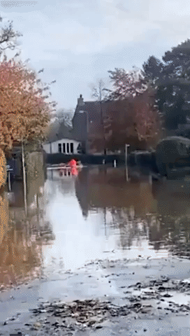 The Mail Must Get Through: Kayaking Postie Surprises Workman in Flooded UK Town