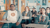 TV gif. Eddie Leavy as Anthony, Tucker Albrizzi as Colin, and Aparna Brielle as Sarika in A.P. Bio. They high five each other when they hear good news from their teacher.