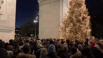 Crowds Gather to Sing Christmas Carols in New York's Washington Square Park