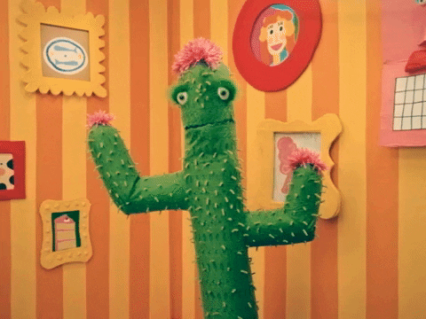 TV gif. A green cactus puppet in Happy Place with pink flowers on its head and arms stands up in a bright cartoonish living space as it says, "You have my whole heart."
