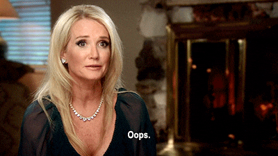 Reality TV gif. Kim Richards talking head from Real Housewives of Beverly Hills, as she shrugs and laughs nonchalantly, insincerely saying, "Oops."
