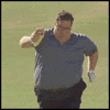 Video gif. A heavier man struggles to run down a field with what looks like a  burrito in his hand.