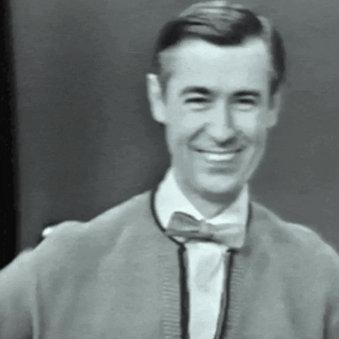 Video gif. Black and white shot of a man smiling as he puts one middle finger up. He continues to smile and look around before putting his other middle finger up. Text, "Happy Monday!"