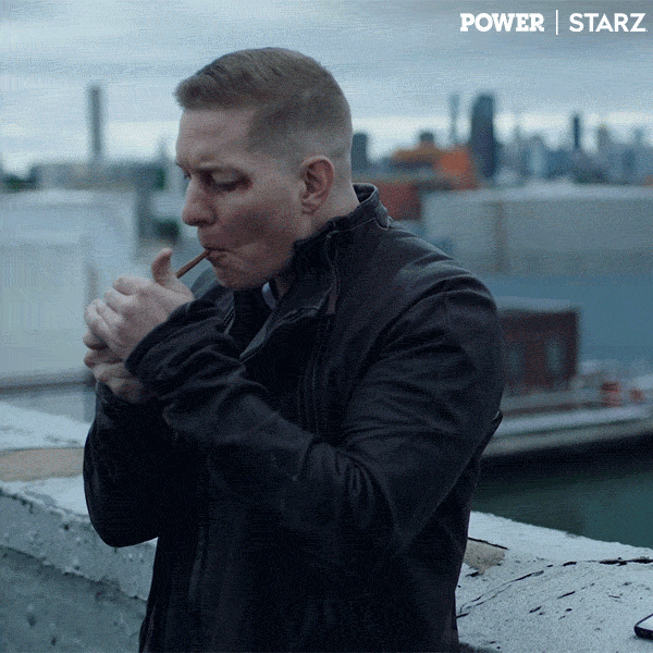 TV gif. Joseph Sikora as Tommy in Power. He stands in front of a shipyard and lights a blunt. He slowly takes a drag from it, relishing the flavor, and looks up at the sky while holding out the blunt and turning to us to say, "Amen."