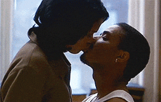 Movie gif. Nia Long and Larenz Tate as Nina and Darius in Love Jones sharing a long, passionate kiss.