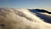 Drone Captures Sunlit Clouds Moving Across North Carolina Mountain
