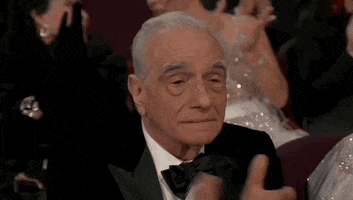 Oscars 2024 GIF. Martin Scorsese applauds, politely bemused.