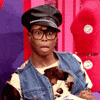 Reality TV gif. Queen out of costume on RuPaul's Drag Race looks out of his large glasses with wide eyes and his mouth open in shock.