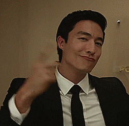 Celebrity gif. Daniel Henney in a suit, pursing his lips in a cool but silly way and pointing at himself while nodding.