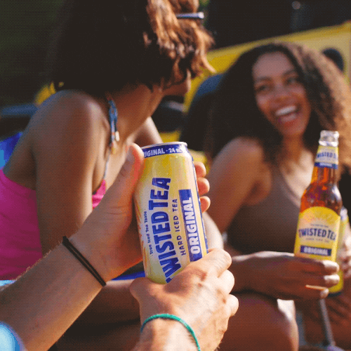 Ad gif. A hand opens the top of a can of Twisted Tea as two woman laugh and smile in the background. 