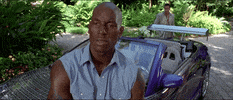 Movie gif. Tyrese Gibson as Roman Pearce in 2 Fast 2 Furious perches on the hood of a car, saying "we hungry."