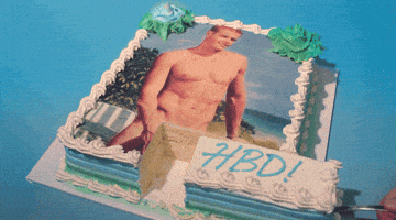 Video gif. White cake with an image of a naked man on it. The cake is cut right at the crotch of the man. Someone is taking that piece of cake, moving it back and forth into place. The piece of cake says, “HBD!”