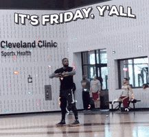 Sports gif. Kyrie Irving with the Cleveland Cavaliers dances excitedly on a basketball practice court, running in place and waving his arms. Animated confetti falls. Text, "It's Friday, y'all."