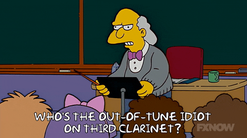 GIF of an episode of the Simpsons where the music conductor says "who's the out-of-tune idiot on third clarinet?".