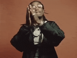 Music video gif. In the video for Want Her, Quavo bites his lip and claps his hands rhythmically.