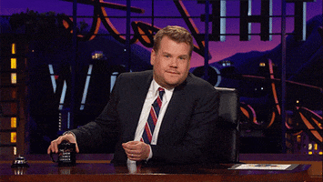 Late Show with James Corden gif. James sits at his desk and nonchalantly takes a drink from his mug, his pinky rising involuntarily. He raises his other hand to push it down but every time he does it rises again. 