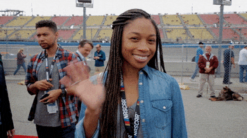 Sports gif. Allyson Felix smiling and waving at Auto Club 400. 