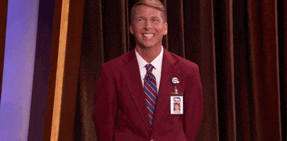 TV gif. Jack McBrayer as Kenneth Parcell in 30 Rock grins sheepishly and raises his hands up innocently, indicating that he has no clue what's going on.