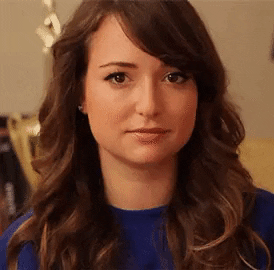 Video gif. A woman tries to wink at us but fails but tries again and again and never succeeds fully succeeds. 