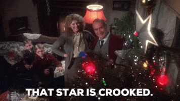 Movie gif. A high-angle shot of the Parker family from A Christmas Story in their living room, admiring their decorated Christmas tree. Darren McGavin as Old Man Parker speaks. Text, "That star is crooked."