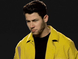 Celebrity gif. Musician Nick Jonas triumphantly raises his hands over his head and pumps a victorious fist. He lowers his arms and pumps both fists in celebration. 