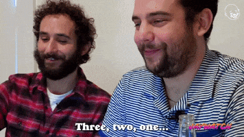 Video gif. Youtubers Jay Weingarten and Eric Rahill count down as they lean in to push a button together. Text, "Three, two, one..."