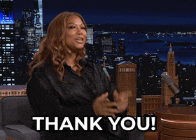 Celebrity gif. Queen Latifah on The Tonight Show pointing toward us with delight. Text, "thank you!"