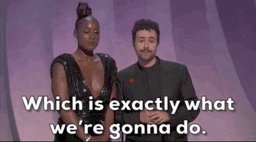 Oscars 2024 gif. Ramy stares sassily at us while Issa Rae says into the microphone, "Which is exactly what we're going to do."