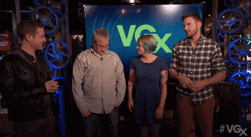 Video gif. Man strikes a smug pose, crossing his arms, the camera zooming in increments on his face at the VGX Awards Show.