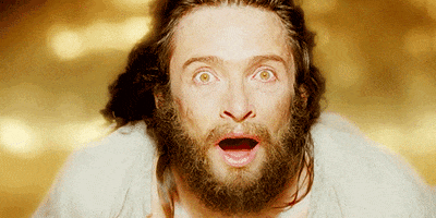 Movie gif. Hugh Jackman as Tomas in The Fountain looking up, awestruck with wide eyes, as wind blows his long hair.