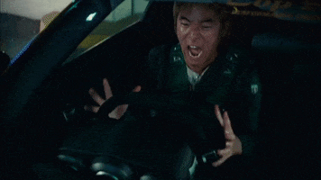 Movie gif. Leonardo Nam as Morimoto in The Fast and the Furious: Tokyo Drift. He's very frustrated at having lost his race and he sits in his racecar yelling and slamming his palm against his wheel, throwing a tantrum.